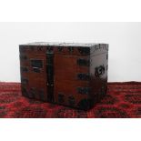 An early 20th century oak and iron strapped domed top silver trunk, with carrying handles,
