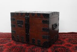 An early 20th century oak and iron strapped domed top silver trunk, with carrying handles,