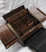 A late Victorian walnut table top stationery cabinet, with a pair of sloping doors,