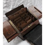 A late Victorian walnut table top stationery cabinet, with a pair of sloping doors,