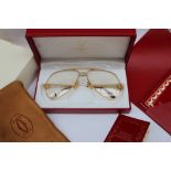 A pair of Must de Cartier Glasses with gilt rims,
