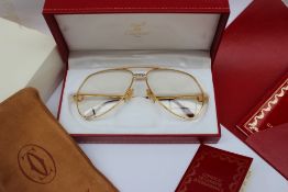 A pair of Must de Cartier Glasses with gilt rims,