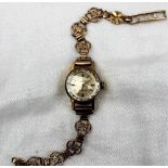 A Lady's Ladymatic 9ct yellow gold Omega wristwatch, with a silvered dial and batons,