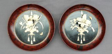 A pair of early 20th century Japanese bone lacquer pictorial wall mounts,