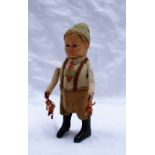 A Schuco figure of a boy in lederhosen 13cm high