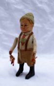 A Schuco figure of a boy in lederhosen 13cm high