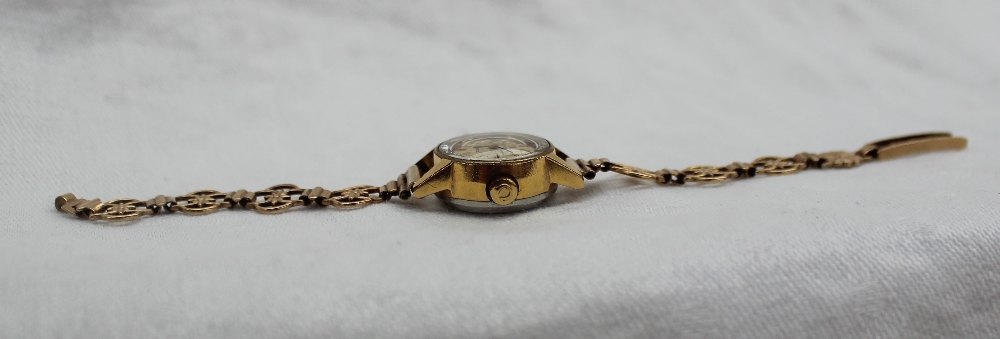 A Lady's Ladymatic 9ct yellow gold Omega wristwatch, with a silvered dial and batons, - Image 4 of 4