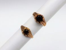A 14ct yellow gold signet ring, set with a round cut garnet to a claw setting, approximately 8.