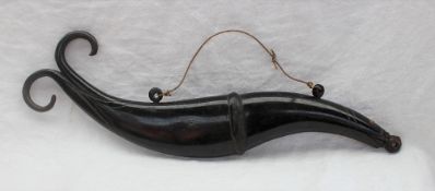 A horn powder flask, in the form of a fish with a scrolling tail, ribbed body and bone eyes, 40.