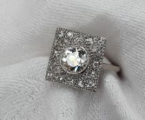 A diamond dress ring of Art Deco style set with a central round old cut diamond approximately 1.