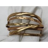 A collection of 9ct gold bangles, approximately 63.