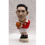 A resin Grogg of Cliff Morgan in red Wales jersey, holding a ball with No.