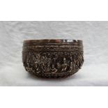 An Indian white metal bowl embossed with figures, scrolls, flowerheads and leaves, 14.
