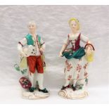 A pair of 19th century continental porcelain figures includes a lady with flowers in her dress and