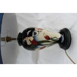 A Moorcroft pottery table lamp, decorated with lilies to a blue to cream graded ground,