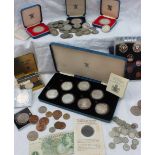 A set of seven silver coins produced to commemorate the 80th birthday of Her Majesty the Queen