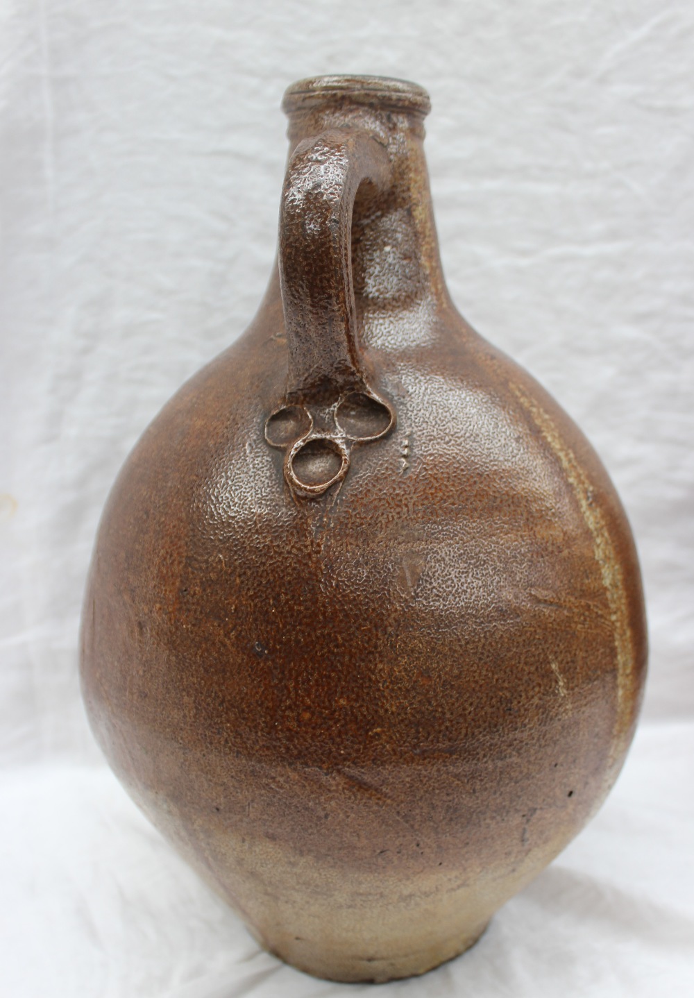 A large 18th century salt glazed Bellarmine mask jug, with a ring handle and finger marks, - Image 8 of 10