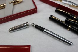 A Sheaffer stainless steel fountain pen together with other Sheaffer fountain and ball point pens