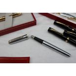 A Sheaffer stainless steel fountain pen together with other Sheaffer fountain and ball point pens