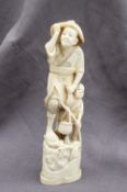 A 19th century Japanese ivory figure group of a fisherman,