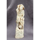 A 19th century Japanese ivory figure group of a fisherman,