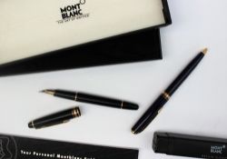 A Montblanc Meisterstuck black and gilt banded fountain pen, with a 14k 4810 nib,