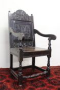 An 18th century oak wainscote elbow chair,