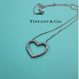 A Tiffany & Co. platinum large outline diamond set heart, approximately 0.