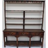 An 18th century South Wales oak dresser, the open rack with a moulded cornice and three shelves,