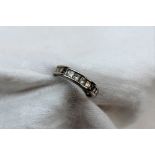 A diamond half eternity ring set with nine princess cut diamonds totalling 1ct to a platinum