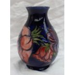 A Moorcroft baluster pottery vase, decorated in the anemone pattern to a royal blue ground,