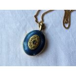 An 18ct gold and blue guilloche enamel and cabochon locket of oval form on a 9ct yellow gold