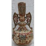 A Fishcher Budapest reticulated pottery twin handled vase, decorated with flowers and jewelling,