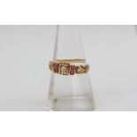 An 18ct yellow gold ruby and diamond ring, set with a central round old cut diamond,