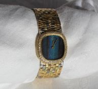 A Lady’s 18ct three gold wristwatch, the rounded square dial with kingfisher feather face,