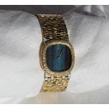 A Lady’s 18ct three gold wristwatch, the rounded square dial with kingfisher feather face,