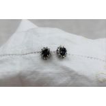 A pair of sapphire and diamond stud earrings,