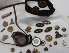 A World War I Vernier's pattern VII compass, together with cap badges,