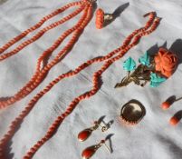 A coral bead necklace together with another coral bead necklace, coral drop earrings,