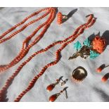 A coral bead necklace together with another coral bead necklace, coral drop earrings,