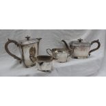 A George V silver four piece tea service, of tapering rectangular form, comprising a hot water jug,