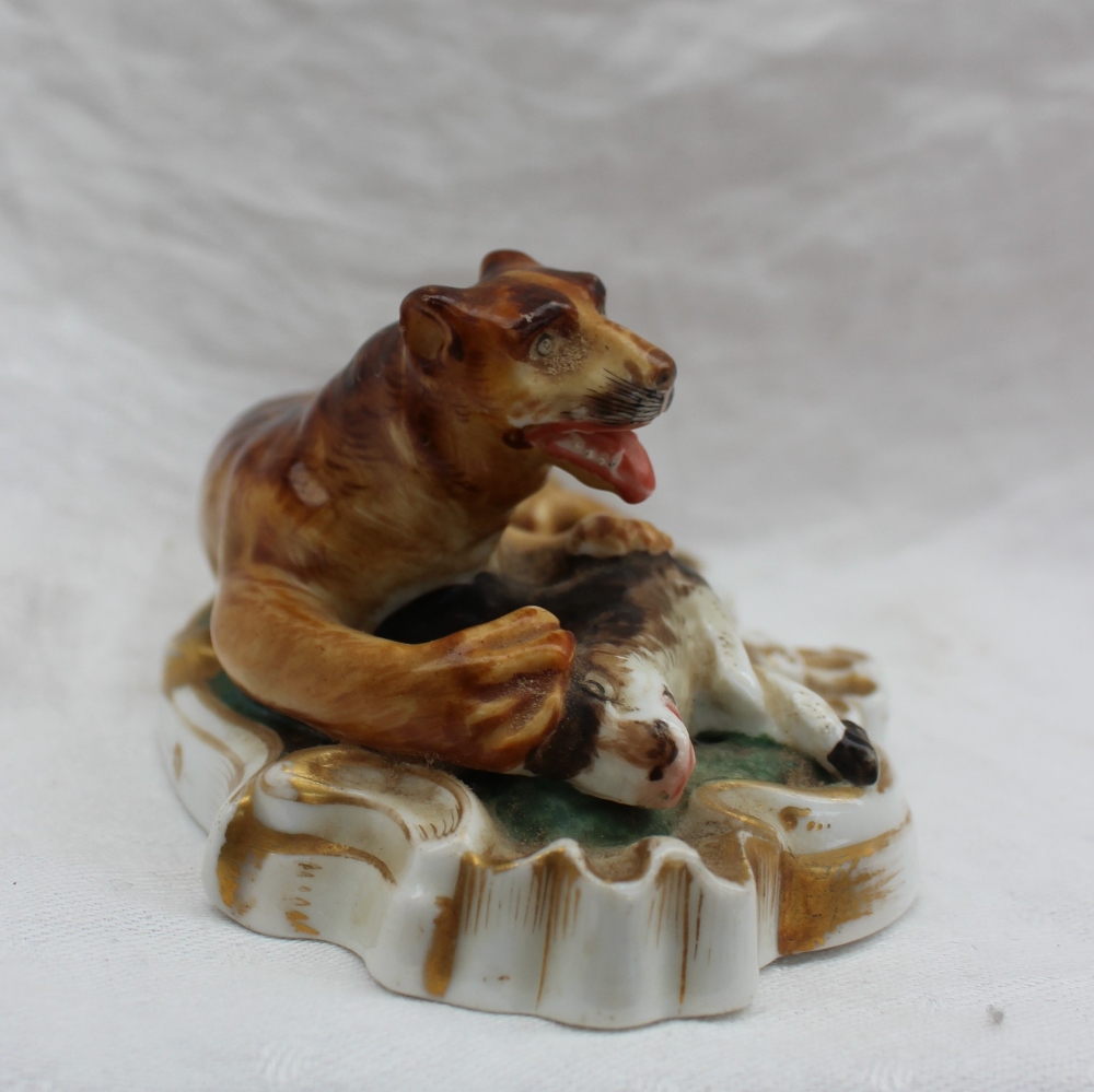 A 19th century porcelain figure group of a lion subduing a deer, on a scrolling oval base, 14. - Image 2 of 4