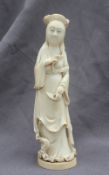 A 19th century Japanese ivory figure of a Geisha with kimono slipping off her shoulder and fan in