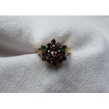 A diamond, amethyst and emerald cluster ring set with four brilliant cut diamonds,