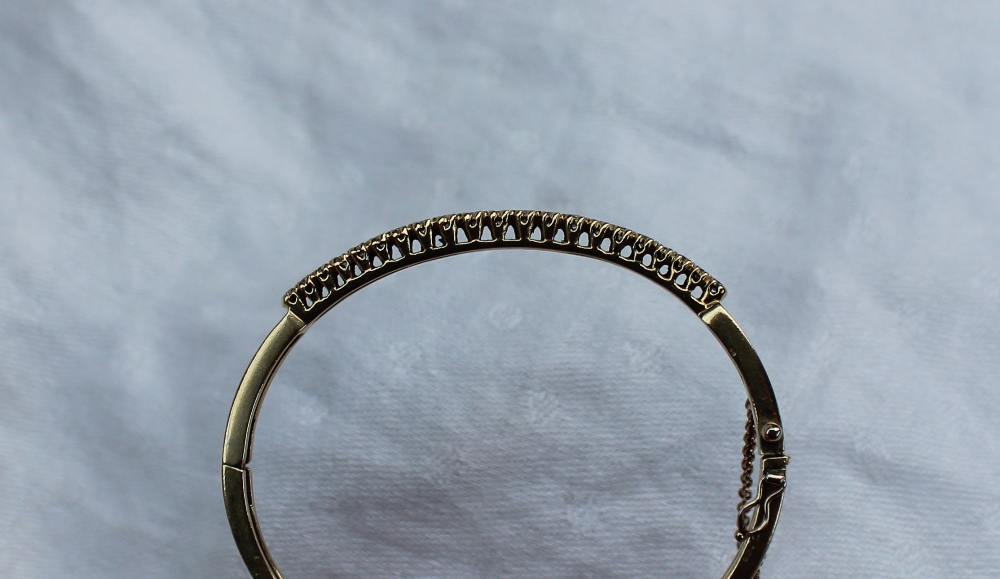 An 18ct yellow gold hinged bangle, set with twenty one round brilliant cut diamonds, - Image 4 of 4