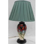 A Moorcroft pottery table lamp, decorated with Poppies to a blue to cream graded ground,