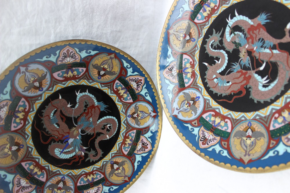 A pair of Japanese cloisonne chargers decorated with dragons and decorative panels, 30.