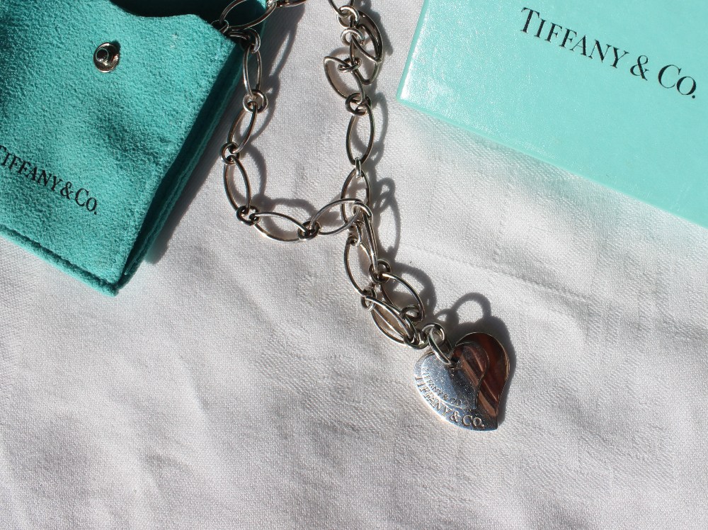 A silver Tiffany & Co necklace, with oval links and a heart pendant, approximately 22 grams,