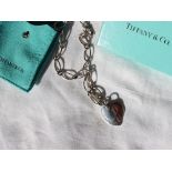 A silver Tiffany & Co necklace, with oval links and a heart pendant, approximately 22 grams,