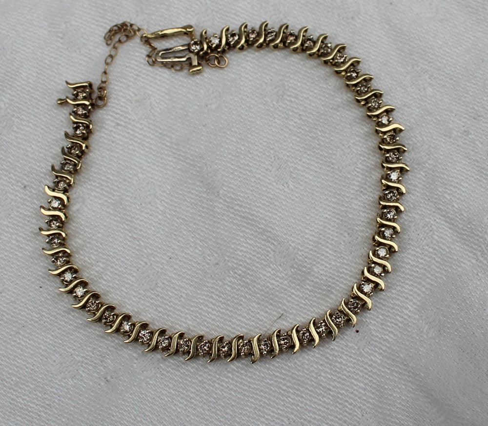 A 9ct yellow gold diamond set tennis bracelet, with S shaped links, approximately 9. - Image 2 of 3